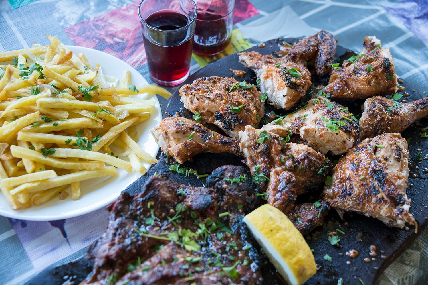 Grilled meat tray with chips and red wine in a restaurant in Tenerife, Canary Islands