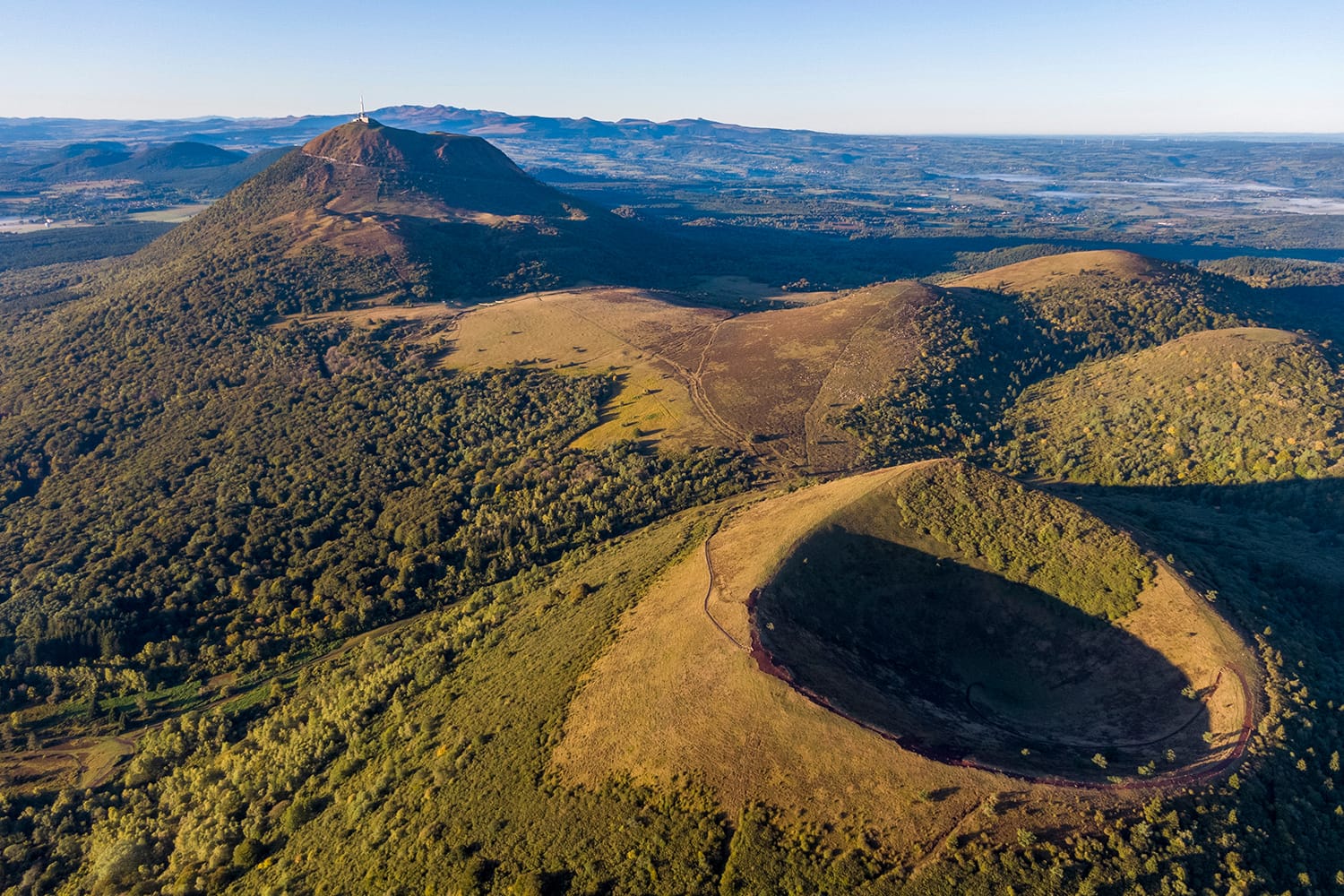 Aerial panorama of Puy Pariou and Puy de Dome volcanoes at Auvergne Volcanoes Regional Park in France