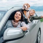 Happy family looking out of car