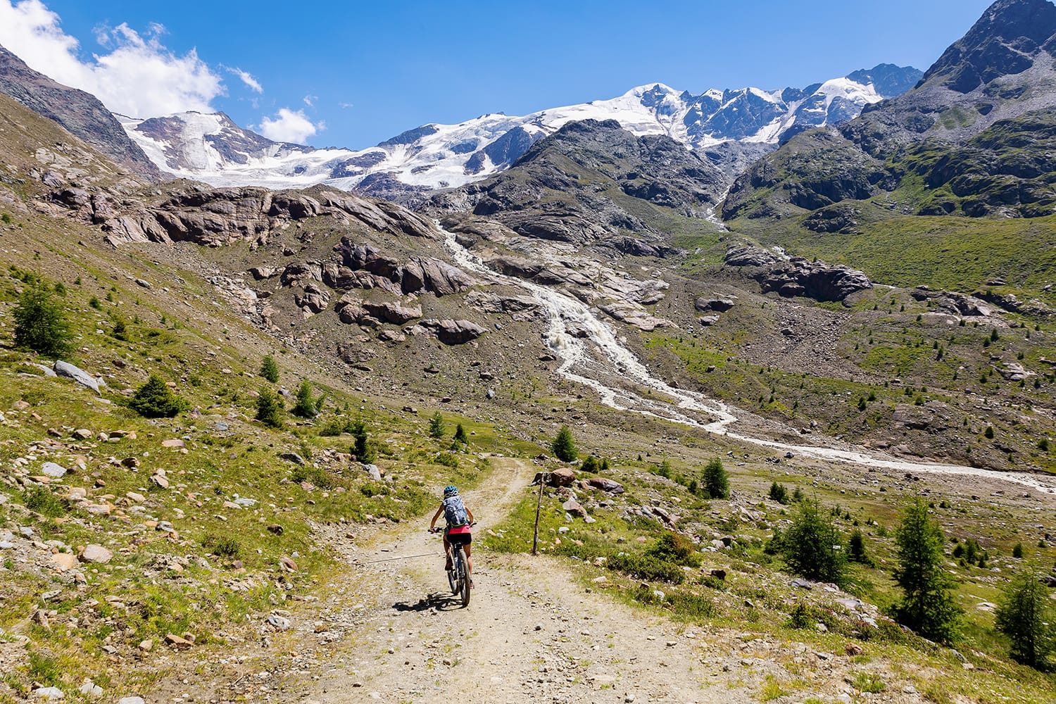MTB excursion in the valley of Forni in the Stelvio National Park, in the background the Forni glacier