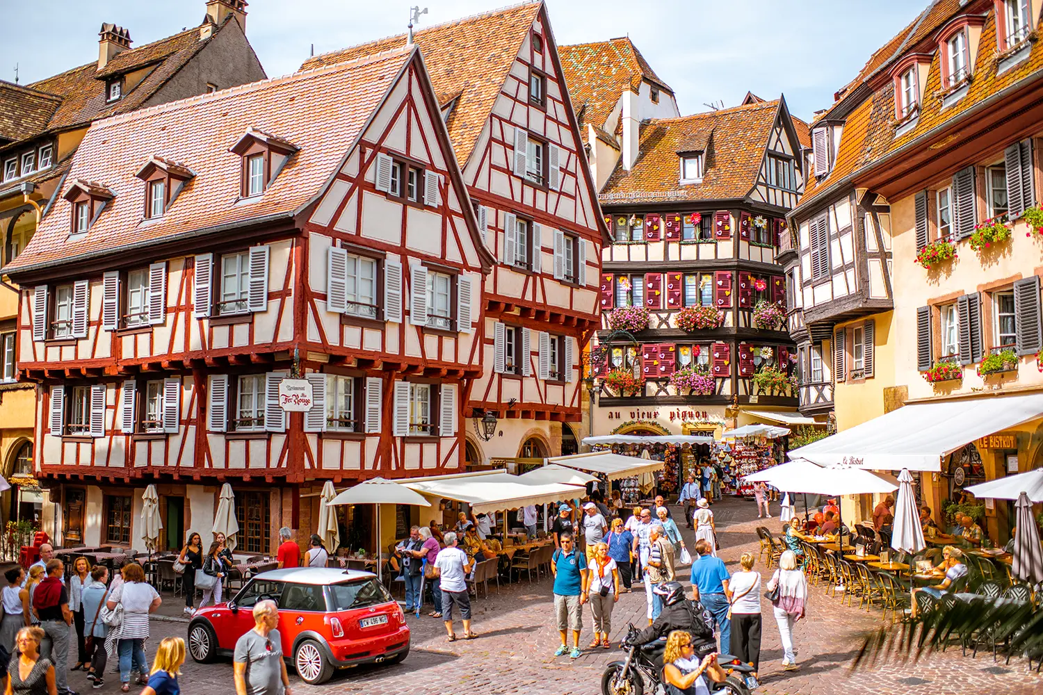 Cityscaspe view on the old town with beautiful half-timbered houses and crowded streets in Colmar, famous french town in Alsace region