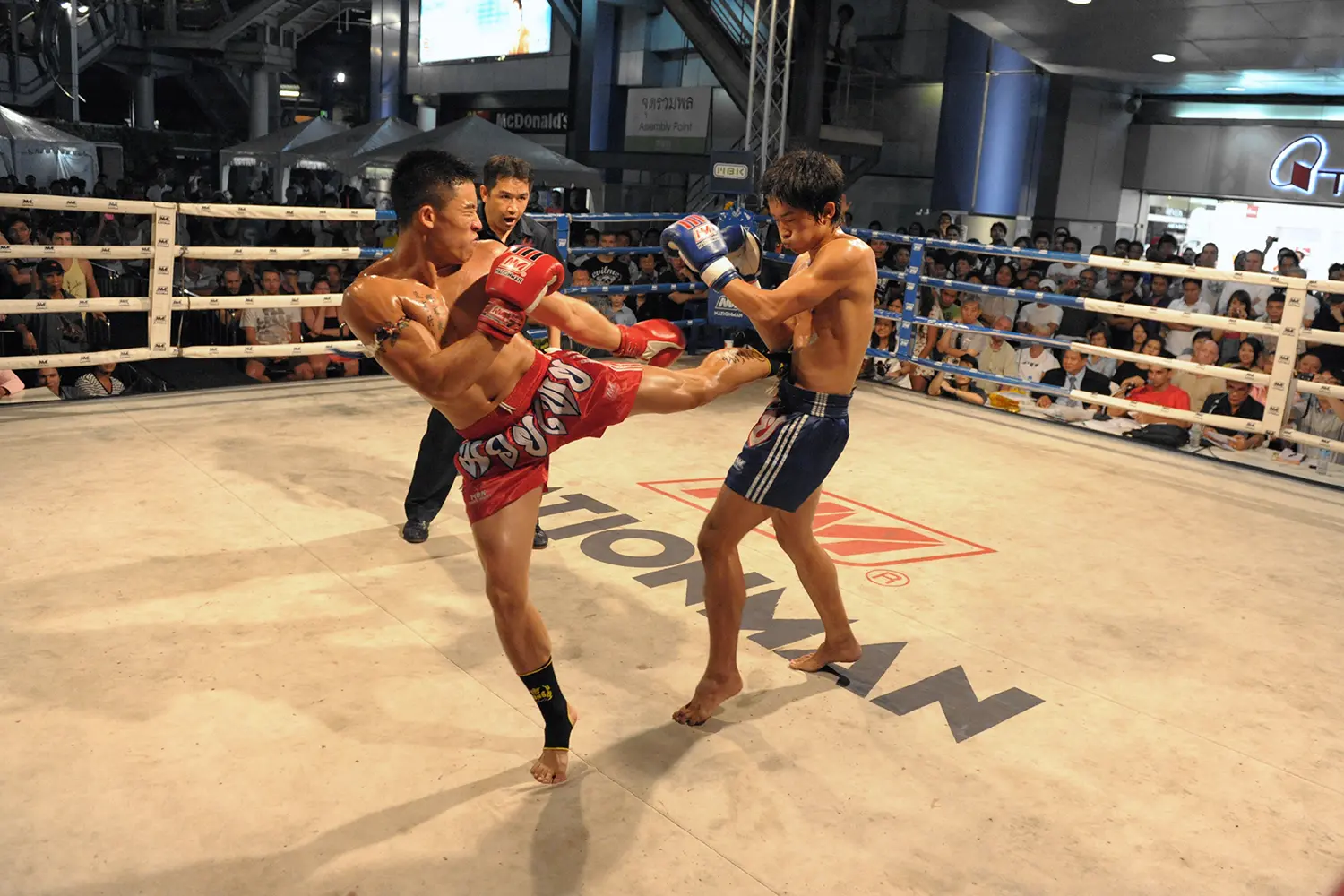 Muay Thai fighters compete in a Thai kickboxing match at MBK Fight Night in Bangkok, Thailand.