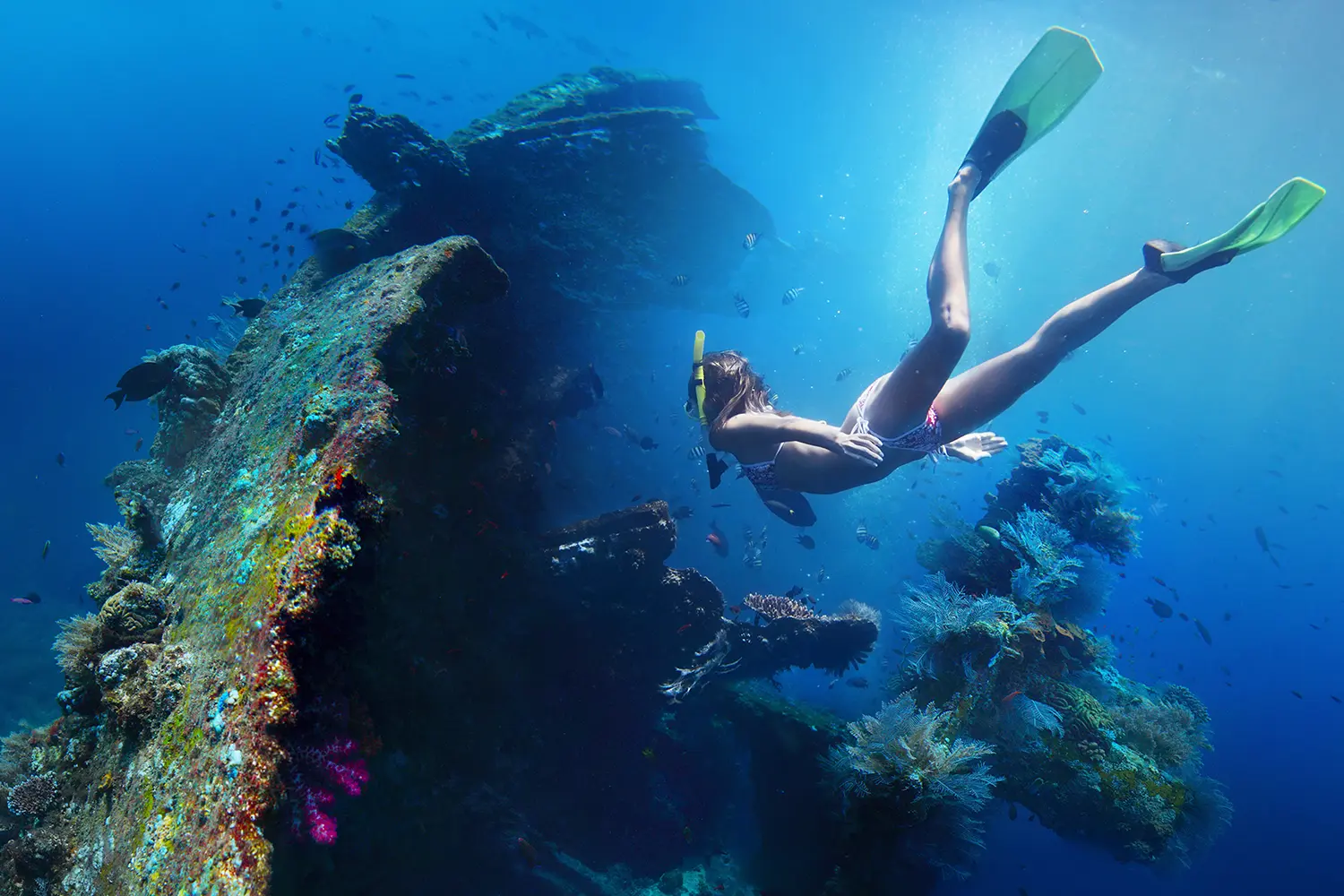 Underwater shoot of a woman exploring USAT Liberty wreck in Bali