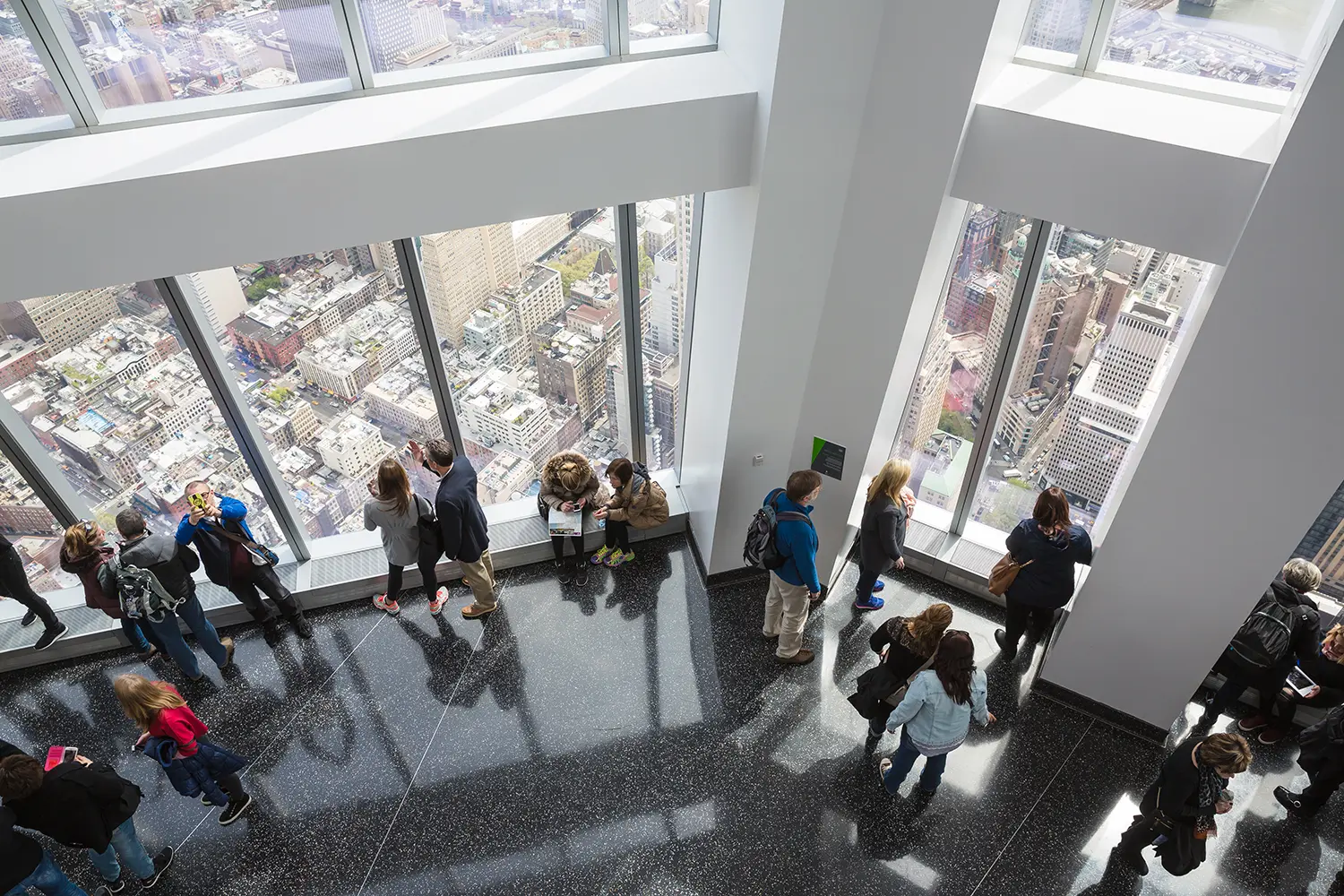 People enjoying the view from the One World Observatory in New York City.