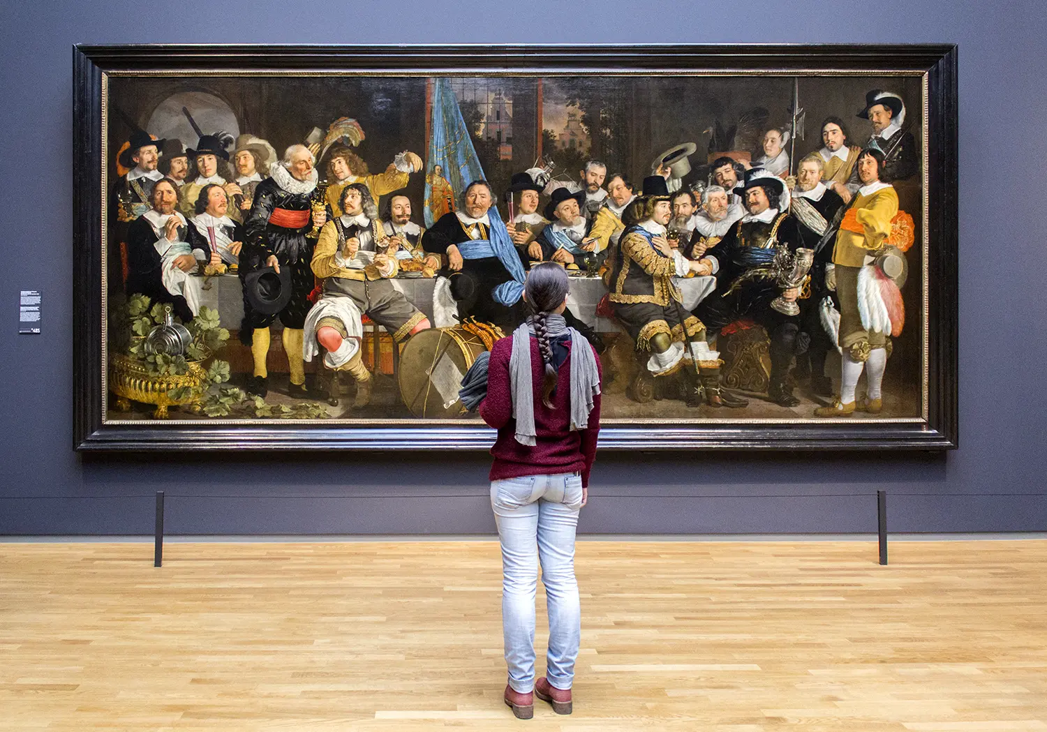 Visitor admiring painting at the Rijksmuseum in Amsterdam