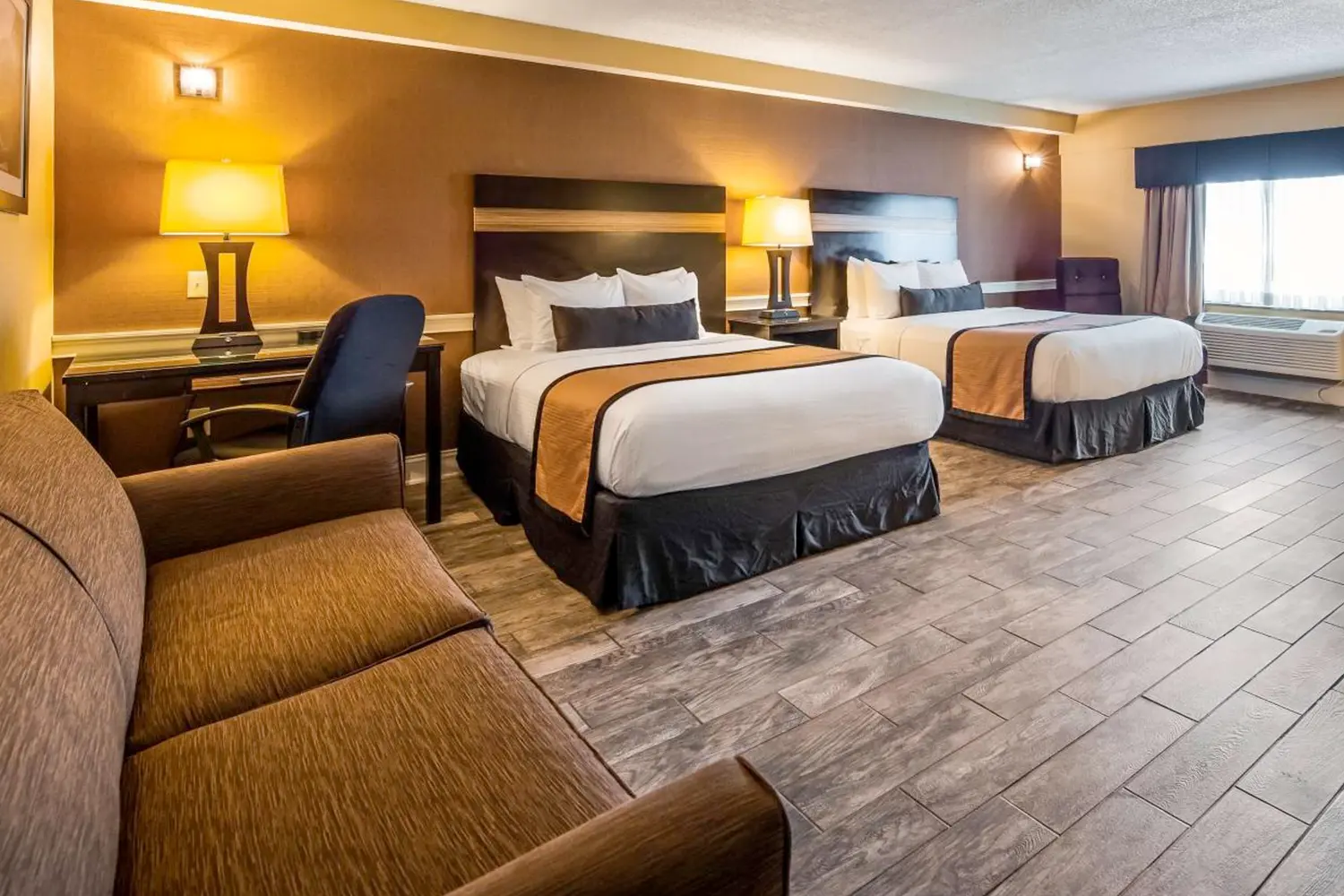 A room with two beds and a couch at Best Western Plus Newark Airport West