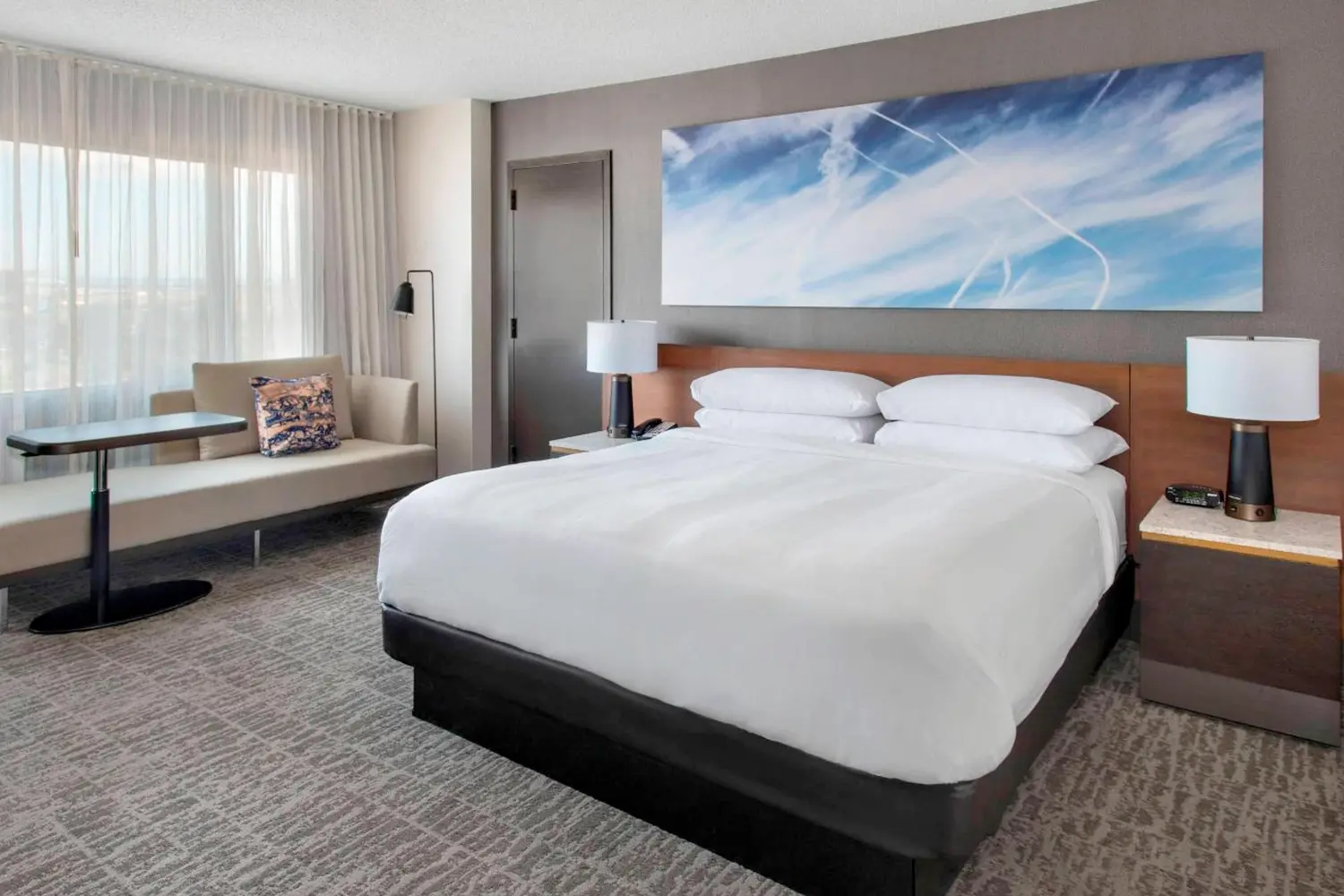 A room with a bed and a couch Marriott Newark Airport Hotel