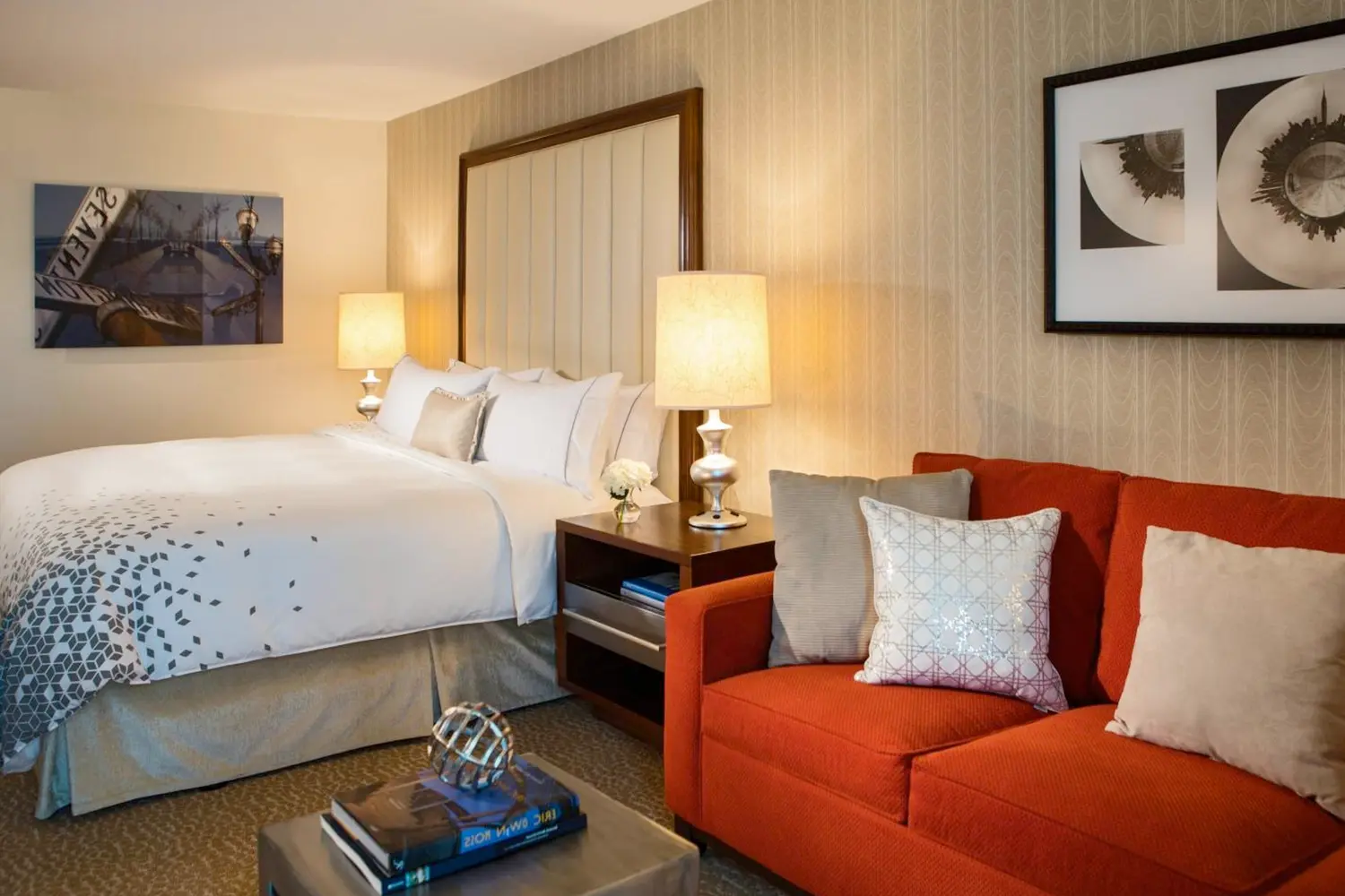 A room with a bed, couch, and table at Renaissance Newark Airport Hotel