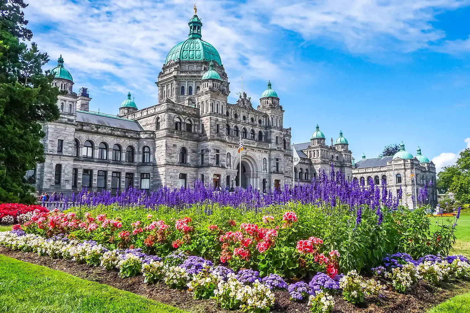 Historic parliament building in Victoria with colorful flowers, BC, Canada