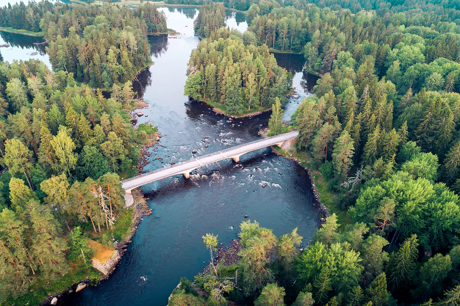 High angle aerial view of bridge connecting islands in a river landscape delta in Farnebofjarden national park, Sweden