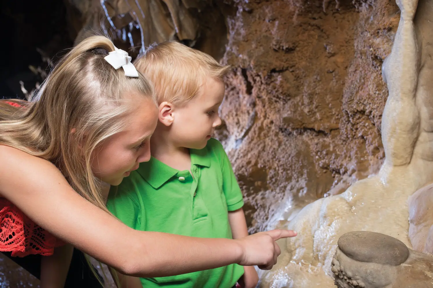 A girl and a boy observing the cavern in Branson, MO.